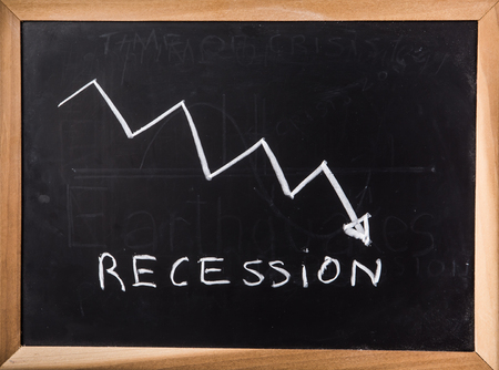 Recession graph on black boardの写真素材