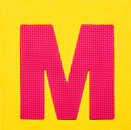 letter "M" on yellow backgroundの写真素材