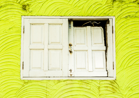 old window on green wall