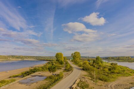 beautiful landscape with blue sky, clouds, road and river