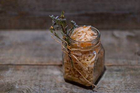 Salad of sauerkraut and carrots in rustic style on wooden background. Selective focus.の写真素材