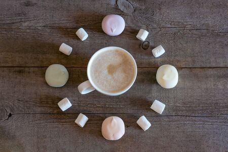 White cup of coffee, cocoa on a wooden background, marshmallows roll in the shape of a clock. Alarm...