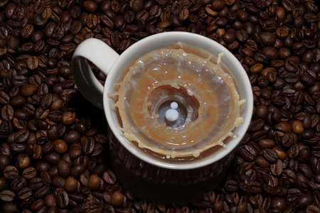 Coffee cup and coffee beans on a wooden table, top viewの写真素材