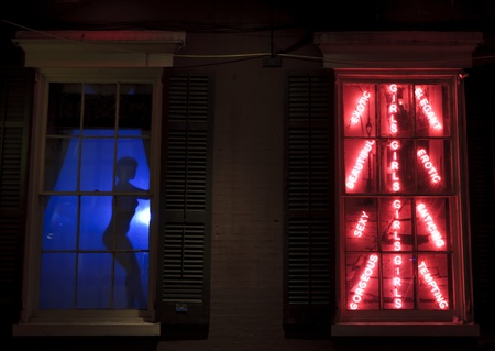 A dancer silhouetted in a window on Bourbon Street in the French Quarter of New Orleansの写真素材