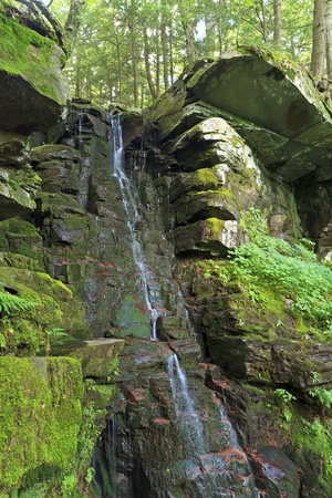A trickle of water spllis through a cleft in the rocks at Wildcat Falls in Kaaterskill Clove in the Catskills Mountains of New Yorkの写真素材