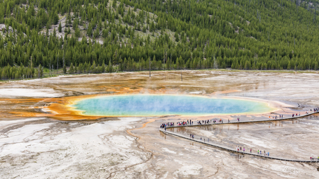Tourists line the boardwalk at the Grand Prismatic Spring in Midway Geyser Basin, seen from above in Yellowstone National Park, Wyoming.のeditorial素材