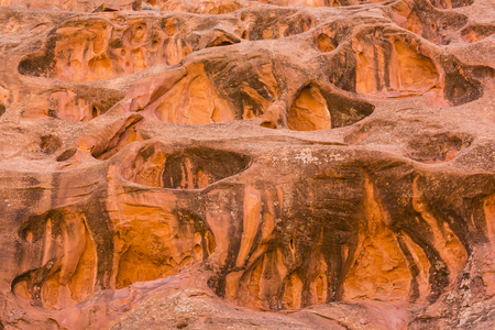 Uniquely eroded swiss cheese red rock formations line Long Canyon on the Burr Trail in Grand Staircase-Eascalante National Monument, Utahの写真素材