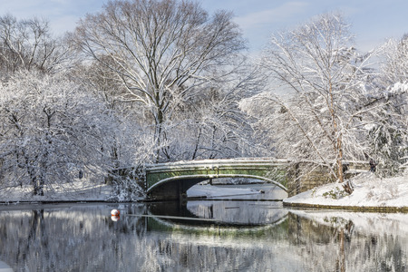 The Lullwater Bridge on Prospect Park Lake after a record Spring snowfall in Prospect Park, Brooklyn, New York.の写真素材
