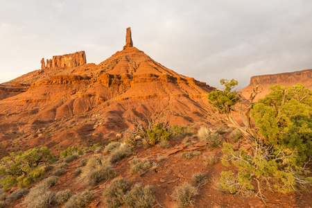 The last warmth of sunlight on Castle Rock, the Priest and the Nuns rock formations in Castle Valley, Utah.の写真素材