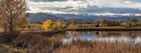 The Flatirons and Front Range of the Rocky Mountains Reflected in Stearns Lake in Autumn in Broomfield, Coloradoの写真素材