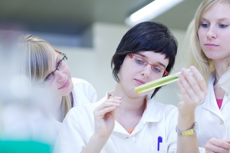 three female researchers carrying out research in a chemistry labの写真素材