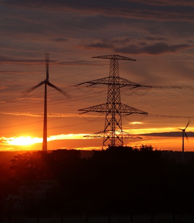 wind energy harvesting wind mills at sunrise