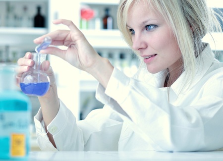Closeup of a female researcher carrying out an experiment in a labの写真素材