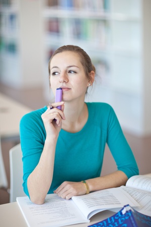 pretty young college student in a library (shallow DOF; color toned image)の写真素材