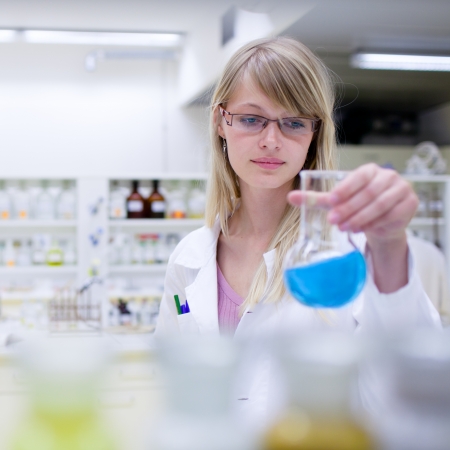 portrait of a female researcher carrying out research in a chemistry lab (color toned image; shallow DOF)