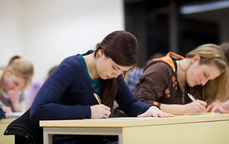 students in a classroom during class/writing a test の写真素材