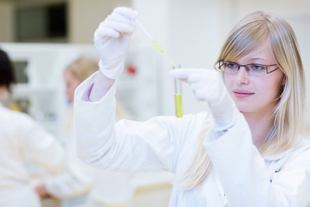 portrait of a female researcher carrying out research in a chemistry lab (color toned image; shallow DOF)の写真素材