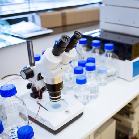 chemistry lab (shallow DOF; focus on the beakers in the foreground)