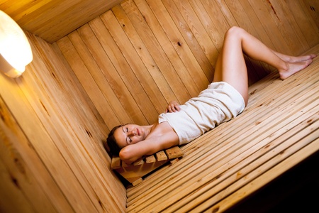 Young woman relaxing in a saunaの写真素材