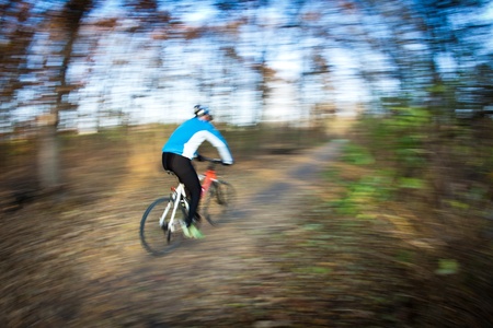 Bicycle riding in a city park on a lovely autumn/fall day (motion blur is used to convey movement)