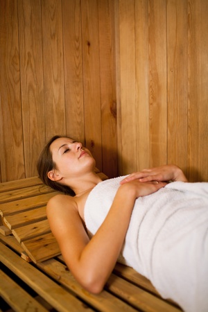 Young woman relaxing in a saunaの写真素材