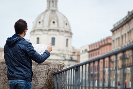Portrait of a handsome, young, male tourist in Rome, Italy  dome of the Santissimo Nome di Maria church in the background の写真素材