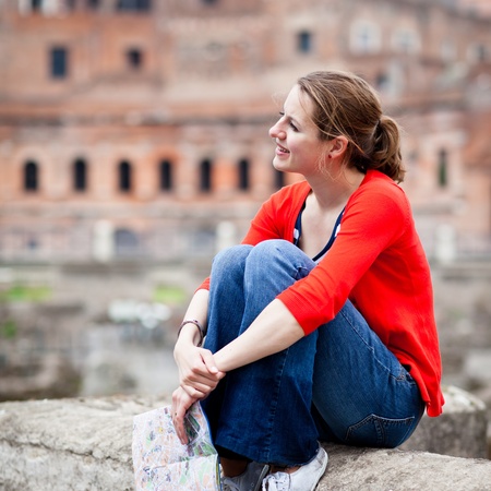 Portrait of a pretty, young, female tourist in Rome, Italy  with Colosseum in the background の写真素材