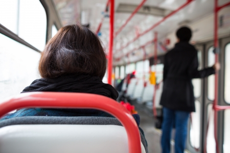 Public transport series - taking a tram commute to work school  color toned image; shallow DOF の写真素材