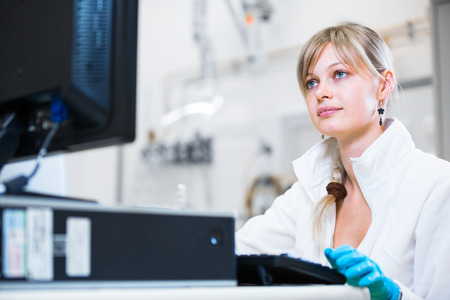 Portrait of a female researcher carrying out research in a chemistry lab (color toned image; shallow DOF)の写真素材