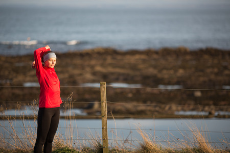 Young woman on her evening jog along the seacoast