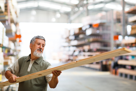 Man buying construction wood in a  DIY store for his DIY home re-modeling projectの写真素材