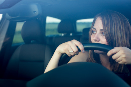 Cute teenager driving her brand new car