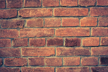 Weathered red brick wall background with vignette eccet, grungy rusty blocks ofcolorful horizontal...
