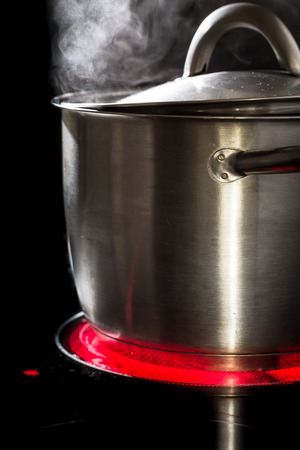 Slowfood - Lovely homemade dish being prepared in steaming pot on kitchen stoveの写真素材