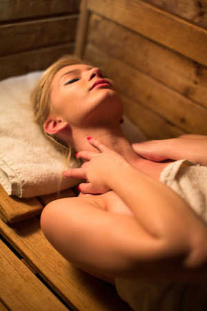 Young woman relaxing in a sauna, taking a break from her busy schedule, taking care of herself, enjoying the wellness benefits her job providesの写真素材
