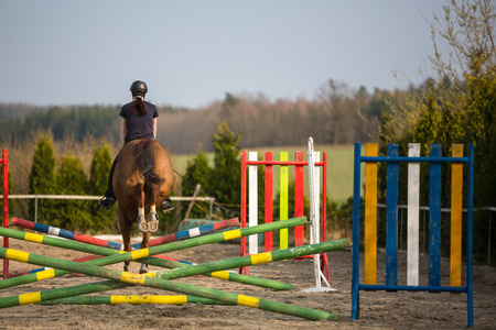 Young woman show jumping with horseの写真素材
