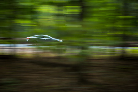 Car going fast on a hughway (motion blurred image)の写真素材