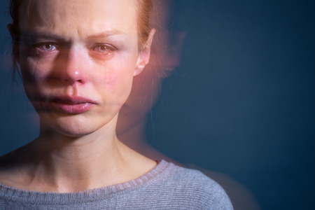 Young woman suffering from severe depression/anxiety/sadness, crying, tears coming from her eyes