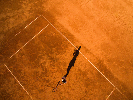 Aerial shot of a female tennis player on a court during matchの写真素材