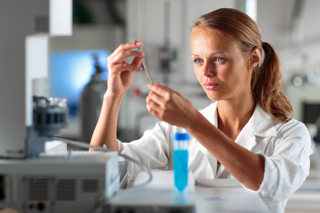 Portrait of a female researcher doing research in a lab, using a tablet computer for data collection...