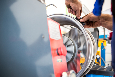 Inside a garage - changing wheels/tires (shallow DOF; color toned image)の写真素材