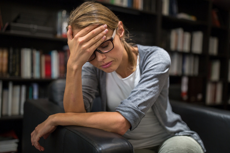 Woman suffering from depression Sitting in a chair (shallow DOF)の写真素材