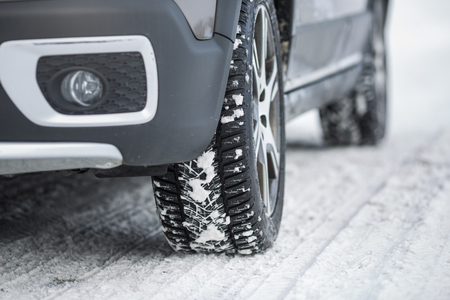 Car with winter tires on a slippery, snowy roadの写真素材