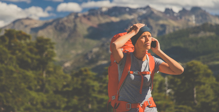 Pretty, female hiker in high mountains , calling for help - being injured and lost