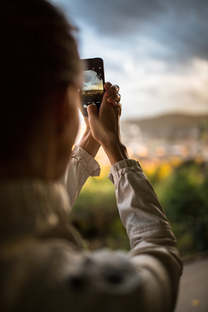 Travel & Discovery - female tourist taking photos of a city while travelingの写真素材
