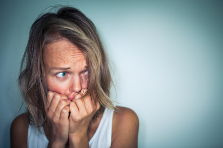 Young woman suffering from a severe depression, anxiety/sudden fearの写真素材