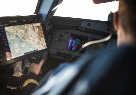 Pilot's hand accelerating on the throttle in  a commercial airliner airplane flight cockpit during...