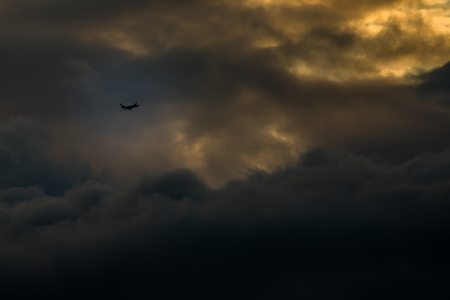 Airplane flying in the sunset sky, travel background with commercial flying airplane. Airplane in the flight - sky background with airplane.の写真素材