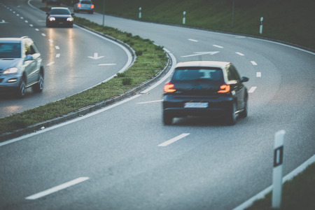 Cars on a highway at night (shallow DOF; color toned image)の写真素材