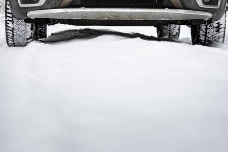 Fast moving car on a winter alpine snowy road